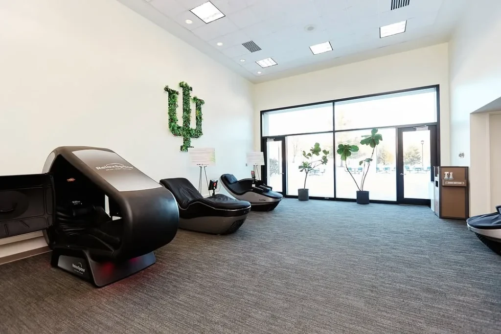 Interior of Indiana University’s wellness studio featuring RelaxSpace and HydroMassage chairs arranged near large floor-to-ceiling windows