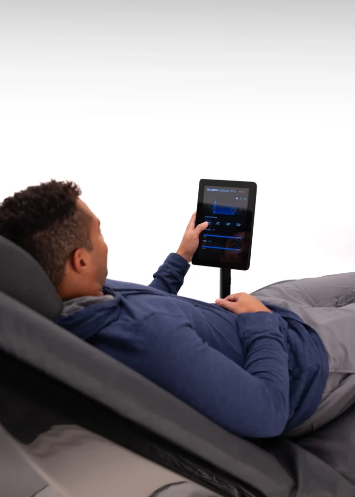 Man using a touchscreen on a HydroMassage chair